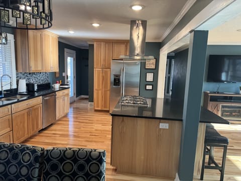 Open kitchen floor plan to dining area and upper level living room. Lake view.