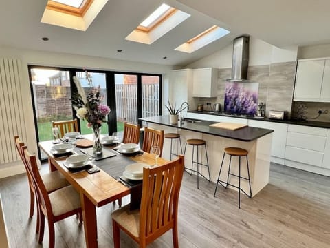 Light and airy, island kitchen and dining space with double bifolds