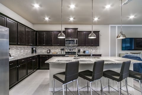 Fully equipped kitchen showing breakfast bar and seating