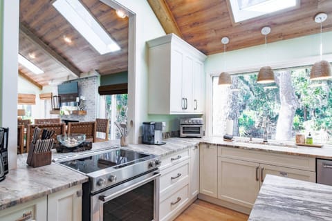 The kitchen also has stainless steel appliances and easy access to the dining areas.