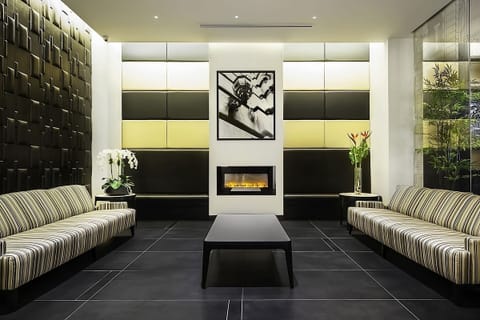 Relax by the glowing fireplace in a stylish, quiet lounge.
