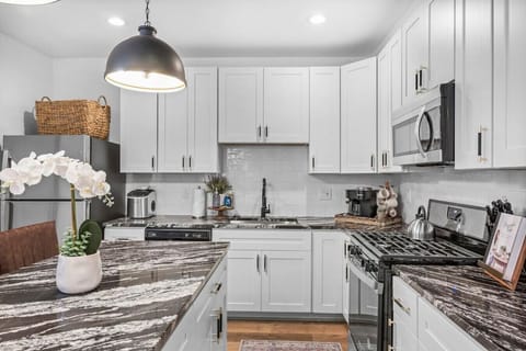 The stylish kitchen is equipped with stainless steel appliances and all the cookware, dishware, and utensils you need to cook delicious meals with friends or family during your stay.