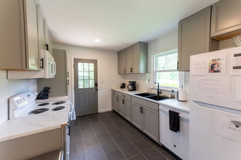 The kitchen features all new appliances, cabinets, and tile as of Fall '22.