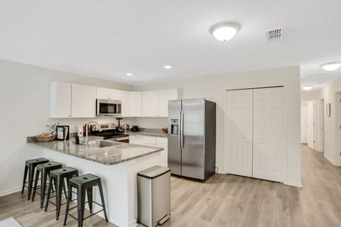Full sized kitchen and refrigerator.
