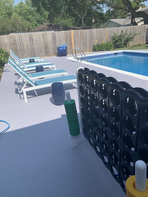 Pool with six chaise lounges and games. 