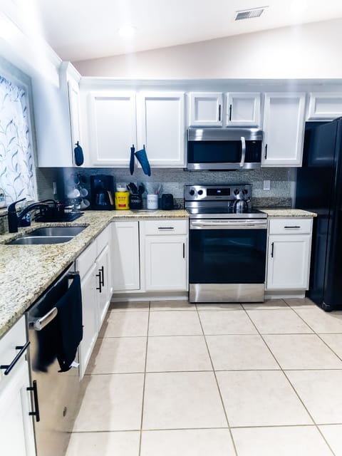 Fully stocked Kitchen with appliances and island with stools
