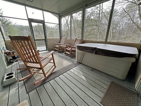Newly redone! What a wonderful screened in porch. Rocking chairs and a hot tub. 