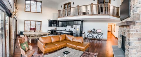 The main gathering area, designed to feel "togetherness" while also having room to have separate activities and conversations. This room has a cozy gas fireplace (shown from a different angle), a full kitchen and dining room area. Plenty of seats for
