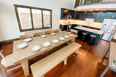 Welcome to our beautiful open-concept kitchen and dining area, the heart of our stunning vacation home. The spacious dining table is the perfect gathering place for family and friends to enjoy meals and make memories together.

The kitchen boasts mod