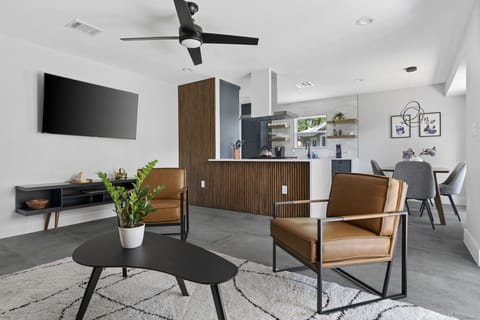 Open-concept living with smart TV, modern style, and seamless flow throughout