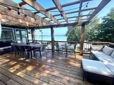 deck with a view. Dining table, bistro table and an l shaped sofa.