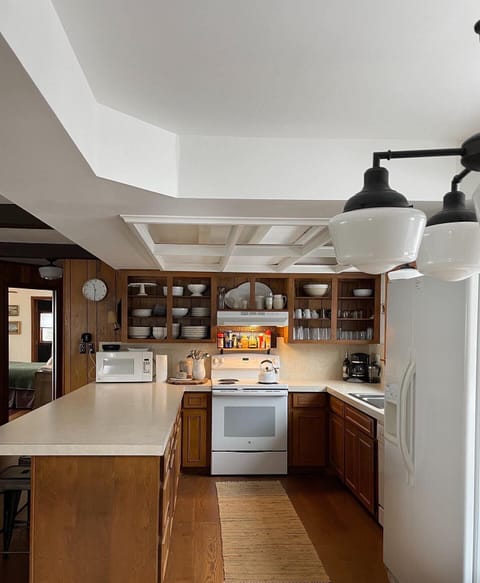 Open concept kitchen with island and bar seating.