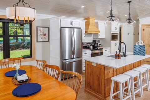 The new, modern kitchen is stocked with everything you need. The dining table seats six with additional breakfast bar seating.