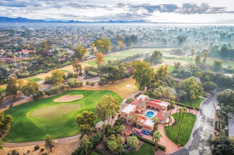 A truly one-of-one ethereal location and stunning atmosphere along with the rhythm of rain drops, dance, and romance in this zen paradise of a corner golf green estate with sweeping mountain views in Paradise Valley.