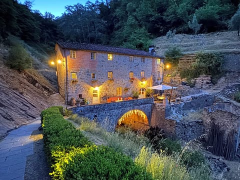 il Mulino Torrigiani with lit walking path.