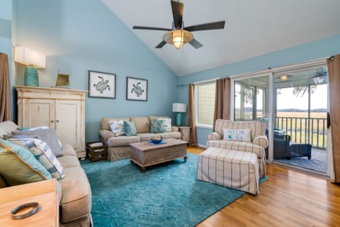 The great room has cathedral ceilings, a wall of windows let you experience the beauty of this  special spot.