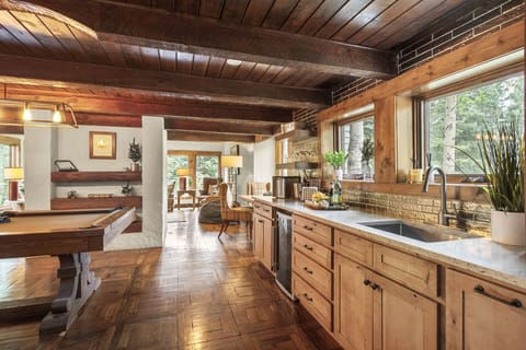 Sophisticated Game Room Bar: The game room boasts a sophisticated wet bar complete with a wine and beverage fridge.