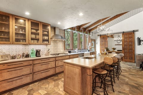 Gourmet Chef's Kitchen: The heart of the home, it offers the perfect blend of functionality and elegance, with the gentle murmur of the creek adding to the ambiance.