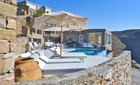 The terrane with pool, sunbeds, umbrellas, BBQ and dining area