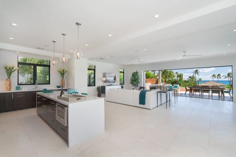 The kitchen overlooks the living area, allowing for easy conversation while preparing meals in your Hawaii vacation retreat.