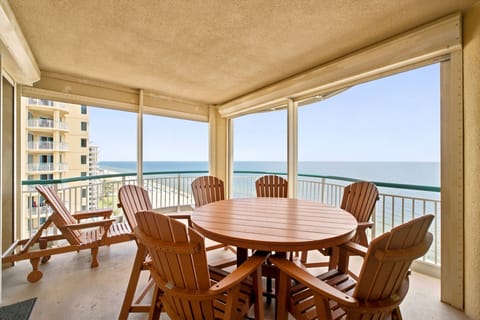 Beach Colony W13A- Your private balcony overlooks the sparkling ocean, perfect for morning coffee or sunset dining with family and friends at the spacious table.