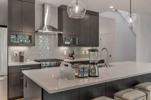 Kitchen outfitted with a suite of essential appliances for your convenience.