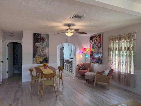Dining and sitting area shows arches to kitchen and bath 1.