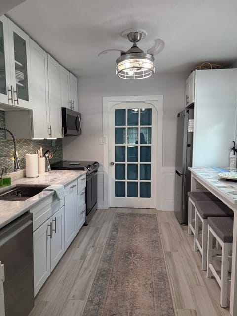 Galley-style eat-in kitchen with french door to bedroom 3.