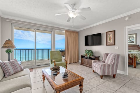 Relax in this bright living room with ocean views and direct balcony access.