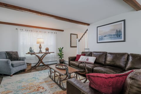 Bright, open-concept living area with comfy seating. Ideal for groups + families