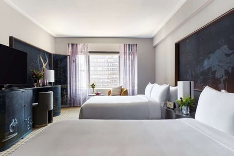Settle in together with two plush beds and bright city light.