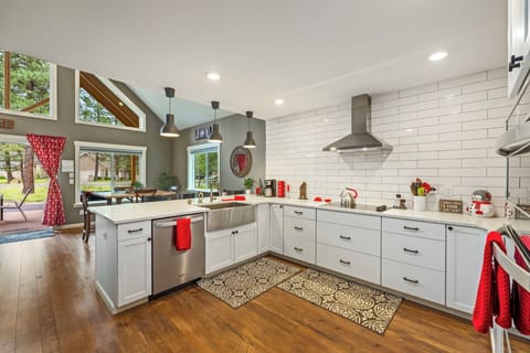 Chef’s kitchen with sleek subway tile, quartz counters, and radiant light