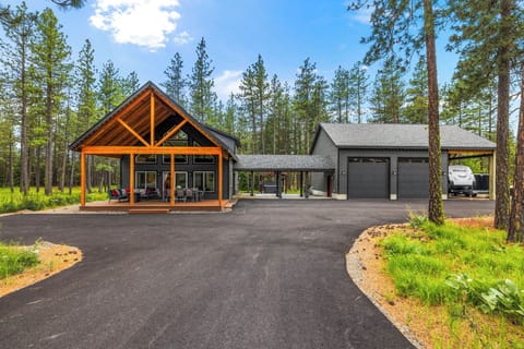 Modern timber-frame cabin with dramatic gables and garage area