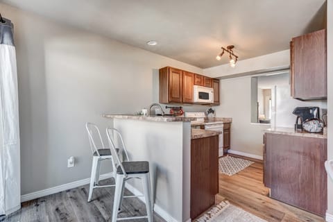 Cozy kitchen with modern appliances and a breakfast bar, perfect for quick meals or a morning coffee.
