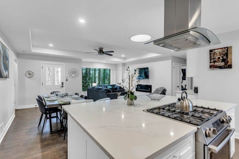 Kitchen Area with island, stainless-steel appliances, washer/dryer - Main House