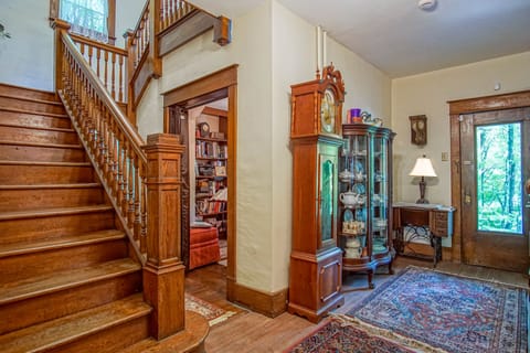 A picture of the stairs that lead to the top floor, reading nook, and the entry way from the front of the home.