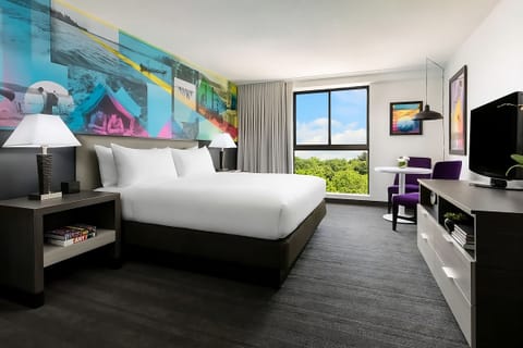 Recharge in a spacious king room framed by lush green views.