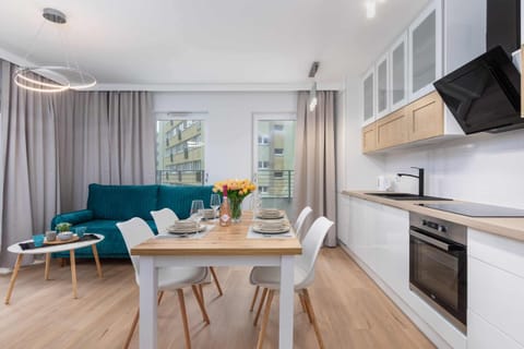 A spacious and bright open-plan kitchen and dining area, with fresh flowers on the table adding a touch of warmth.
