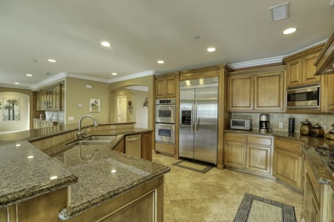 Sand Castle Kitchen - The granite kitchen island and countertops offer generous space to prepare your daily catch, while sampling a California Central Coast wine pairing.