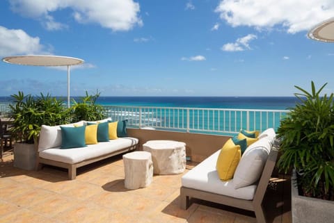Unwind on plush loungers with endless oceanfront blue views.