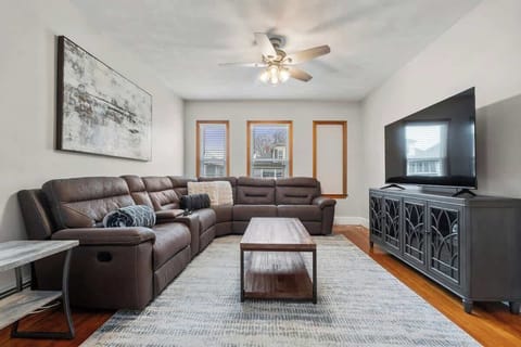 Living room with 65" Smart TV and wrap-around sectional for 6