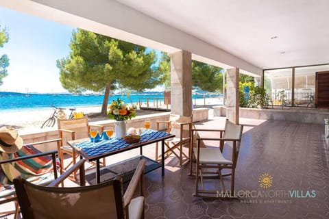 Spacious covered terrace with panoramic sea views and direct beach access. Enjoy outdoor dining in a relaxing setting, surrounded by nature and the sea breeze. A perfect space to unwind and experience the tranquility of the Mediterranean