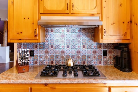 Custom tile lines the stove area.