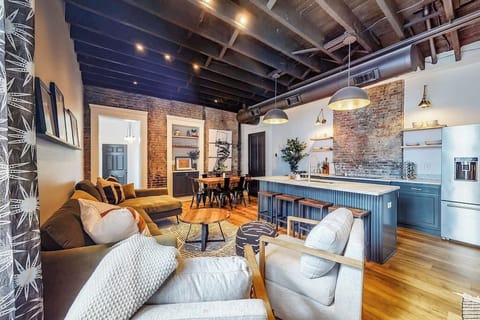 Living Room: The rustic modern design adds warmth to the room, featuring a large sofa, two spacious couches, and a comfy bean bag.