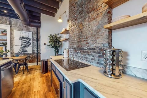 Kitchen: Our kitchen has a spacious counter, organized wooden cabinets, stainless steel appliances, and utensils.