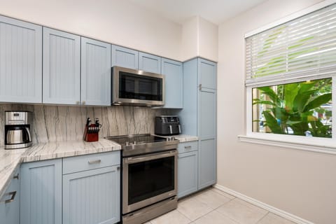 Full kitchen with marble style counters and stainless steel appliances