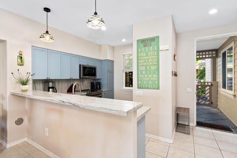 Full kitchen with marble style counters and stainless steel appliances