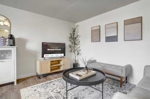 Welcome to our inviting living room, featuring a Smart TV, cozy couches, and an abundance of natural light pouring in through the windows – the perfect spot to unwind, watch a movie, and enjoy quality time with your family
