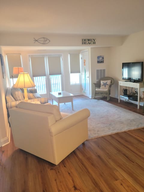 Open floor plan-
living room/kitchen with LVP flooring and television. 
