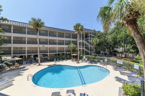 Enjoy a dip in the outdoor pool steps from the condo